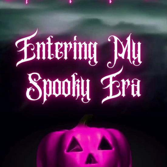Editable pink spooky halloween party party video invitation displayed on a mobile phone, featuring an animated vertical digital invite with music, created in Canva. This premium video invitation template is designed for sharing by text, email, and social media and works with an interactive RSVP website for easy guest response tracking.